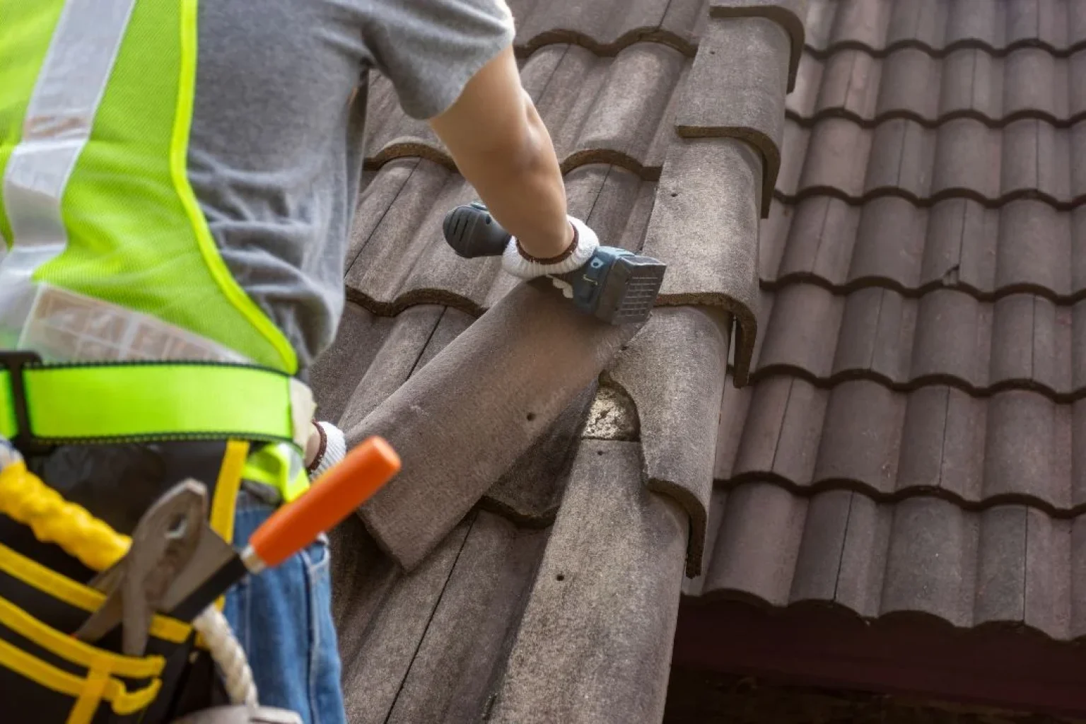 Reliable Roofing Near Me contractor repairing cracked tiles on a Phoenix home before monsoon storms